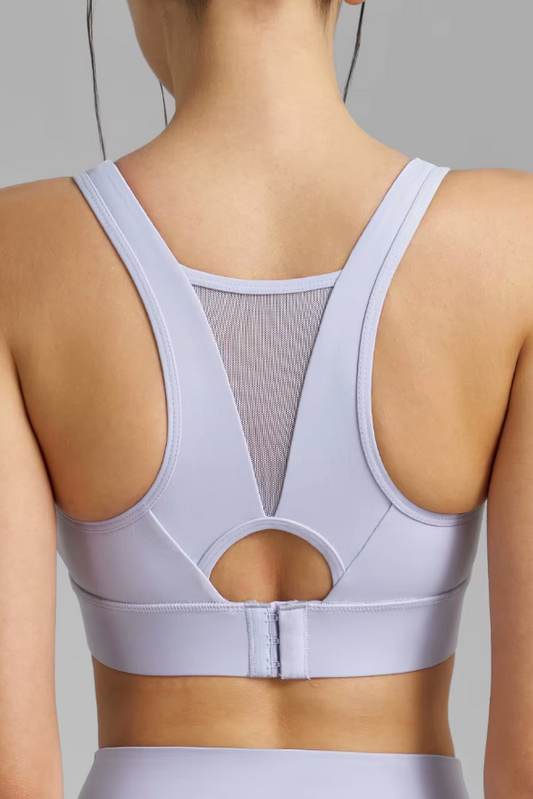 Light purple sports bra worn by a person on a gray background